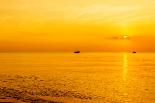 morning sky panoramic view of tropical surfers at sunset