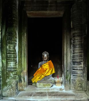 God Vishnu statue in Robe orange cloth of Buddhist in Temple Angkor Wat, Siem Reap, Cambodia.