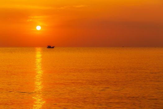 Sea wave beautiful sunset cloudscape. fishing boat in the sea
