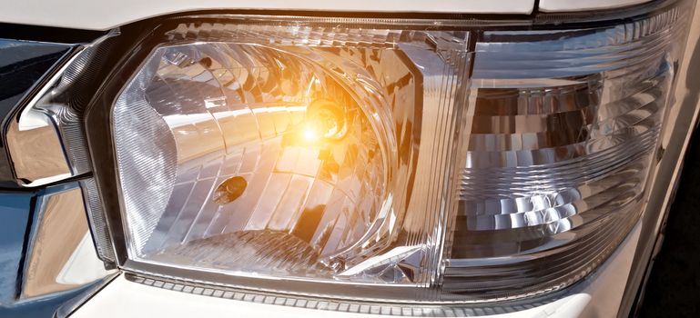 Headlight of a car banner background.