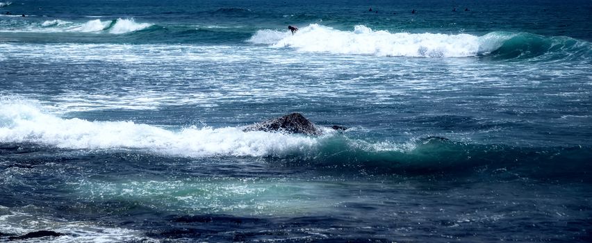 Surfer man on Blue Ocean Wave Bali Indonesia water sport lessons swimming activity riding waves