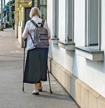 Rudas Therapeutic Thermal Baths (Rudas Gyogyfurdo) the most popular medieval bath in Budapest. Woman With A Cane Walking The Street BUDAPEST HUNGARY.