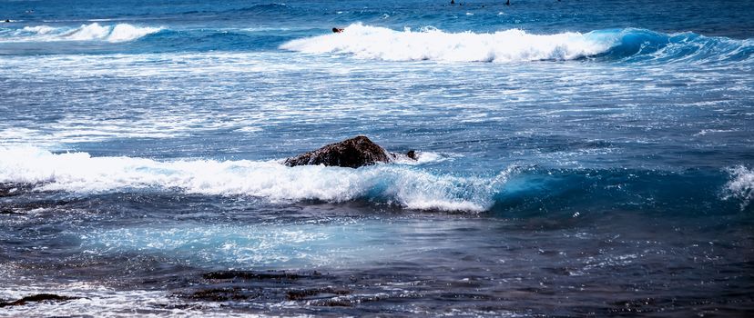 Surfer man on Blue Ocean Wave Bali Indonesia water sport lessons swimming activity riding waves