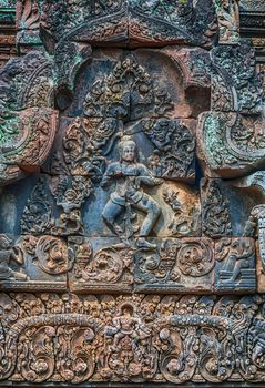 Banteay Srei Bas-reliefs are individual figures jungles of ruins Angkor. Banteay Srey temple Angkorian sites in Cambodia.