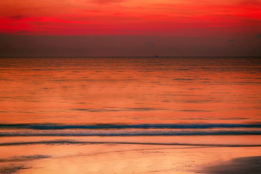 Summer background evening beach at sunset with waves