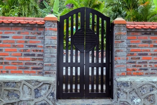 Wooden doors or gate symbol of buddhism endless knot fence brick red building construction