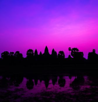 Panorama Palm trees Mist sunrise tropical morning violet facade silhouette Cambodia World famous buildings. Angkor Archaeological Park near Siem Reap in Cambodia