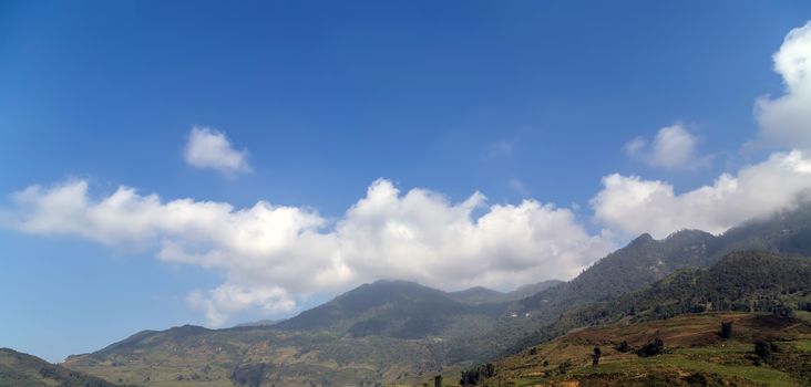 Mountain cloud top view landscape range view. Mountain peak blue sky white clouds panorama. Vietnam landscapes.