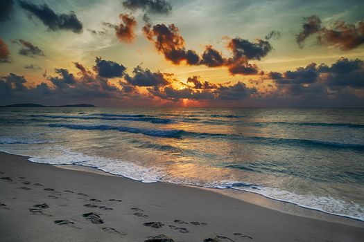 evening beach at sunset with waves