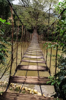 old wooden foot bridge river tropical forest