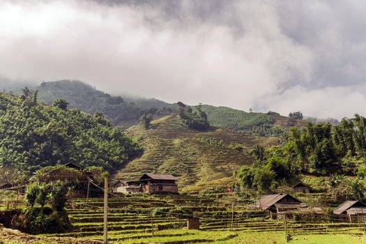 Panorama rice fields terraced rural traditional village huts Vietnam landscapes. Mu Cang Chai Sapa Southeast Asia.