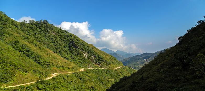 Curved way countryside mountains landscape summer with cloudy sky country road