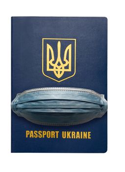 Medical mask in Ukrainian foreign passport international document. Coronavirus or Covid-19 quarantine travel concept.