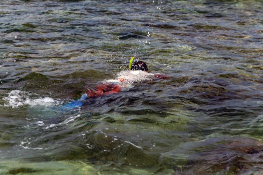 World Water Day, young man diving snorkeling swimming in blue sea.