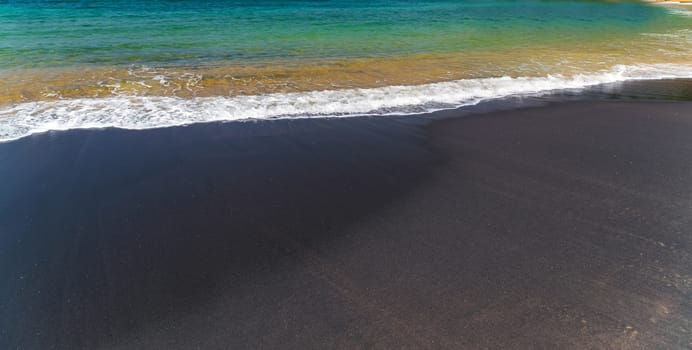 World Water Day tropical beach, Vulcan black sand coast in the town of Mirissa, Sri Lanka