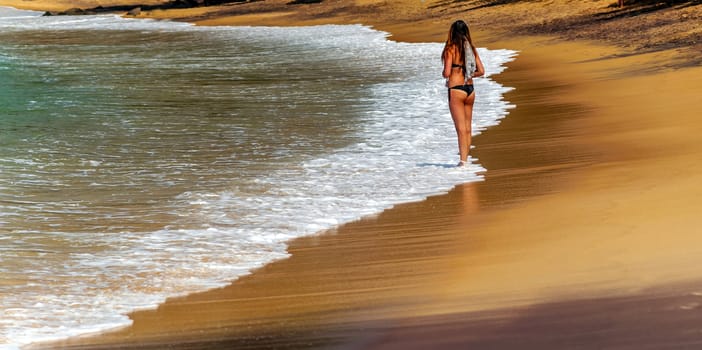 Summertime Woman in a Tropical beach and clear sea shore bay of Mirissa. World Water Day