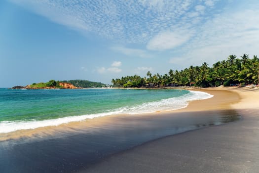 Water Day tropical beach black sand coast in the town of Mirissa, Sri Lanka