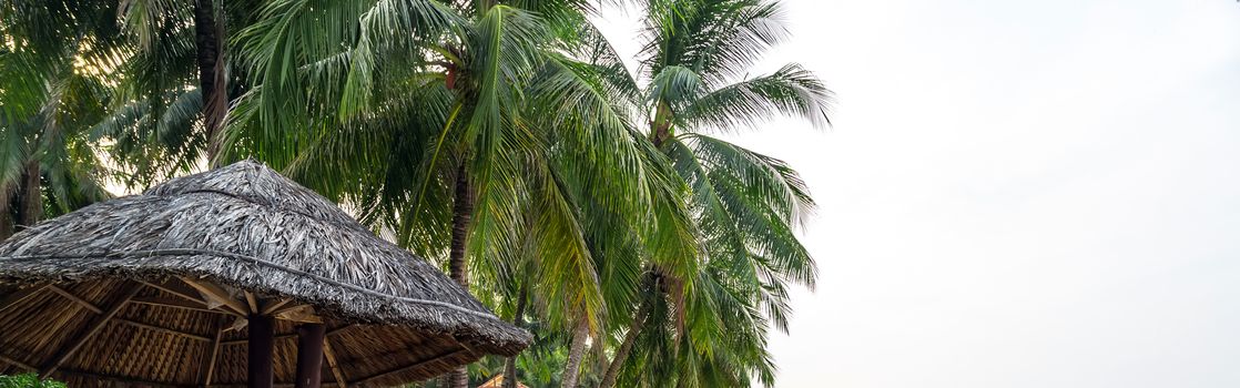 Place to relax shadow from a coconut tree. Leisure at sea. Umbrella Phu Quoc island in Vietnam.