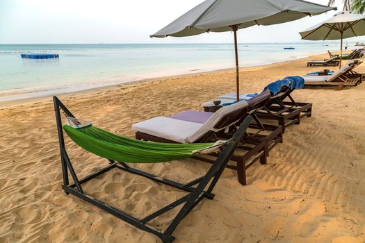 Caribbean Rest On Beach chairs swing or hammock and white umbrella Summer background Phu Quoc island in Vietnam. scene vacation and summer holiday concept.