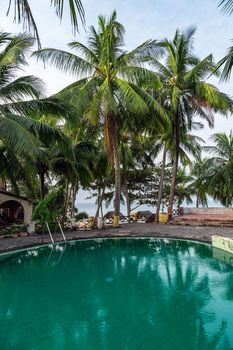 Tropical relax outdoorprivate swimming pool panoramic sea view at luxury villa. Poolside for relax. Silhouette coconut palm tree