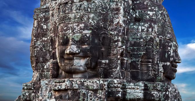 Khmer Smile Buddhist Stone face in Bayon Temple Angkor Thom, Cambodia. Ancient monument Khmer architecture.