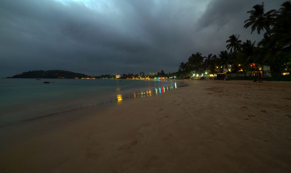 Sunset view of tropical restaurants. Ocean coast of Mirissa, Sri lanka