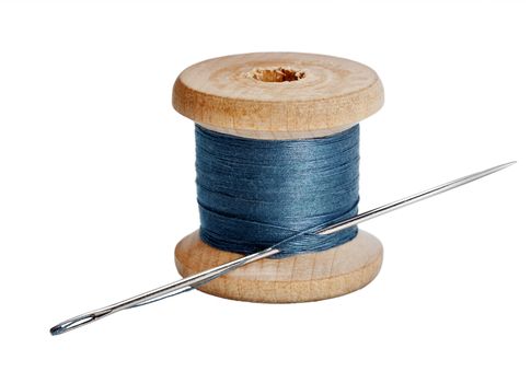 Needle and wooden spool thread isolated on white background