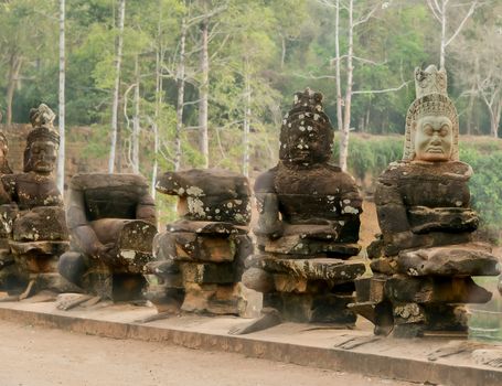 Stone Asura Row of sculptures on bridge ancient Angkor Thom in Siem Reap, Cambodia.