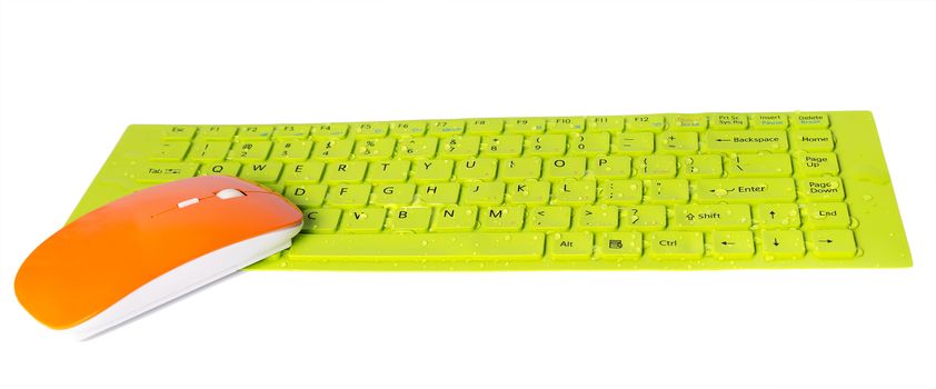 orange computer mouse water droplets on green button key of keyboard isolated on the white background