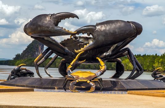 KRABI - 10 MARCH 2015: Crab statue in the cite centre town, monument is located on the bank of the river of Krabi, Thailand. Photo of Krabi landmark Kanaab Nam Cliff Krabi province.