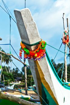 Sri Lankan traditional fishing catamarans, Colorful fishing old boats on a long sandy beach on the ocean coast of Sri Lanka. Popular landmark fishing Ceylon village.