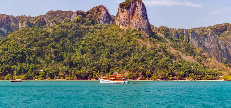 boat in tropical resort and limestone rocks island andaman sea in Krabi, Thailand.