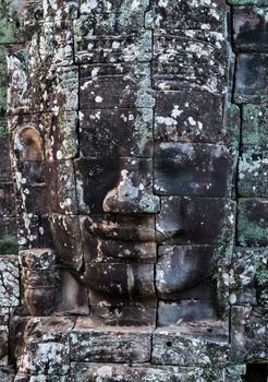 Buddhist Stone face in Bayon Temple Angkor Thom, Cambodia. Ancient monument Khmer architecture.