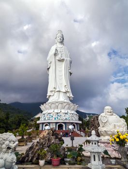 White Buddha statue on blue sky background. Lady Buddha (the Bodhisattva of Mercy) at the Linh Ung Pagoda, Danang (Da Nang), Vietnam.