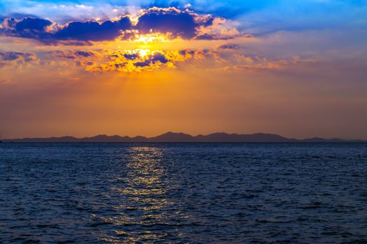Sea Sunset Beach, paradise evening mountains island. Beauty Scene or sun over colorful sky with clouds Seascape. Tourism travel, vacation concept tropical nature background