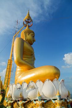 Stone statue of Buddha sitting in lotus pose gold-plated. Tiger Cave Temple Wat Tham Sua Krabi Province Thailand