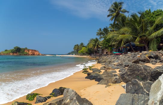 Beautiful bay with white sand beach, blue water and big boulders, Parrot Rock Mirissa Sri Lanka