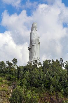 Lady Buddha (the Bodhisattva of Mercy) at the Linh Ung Pagoda, Danang (Da Nang), Vietnam. White Buddha statue on blue sky background.