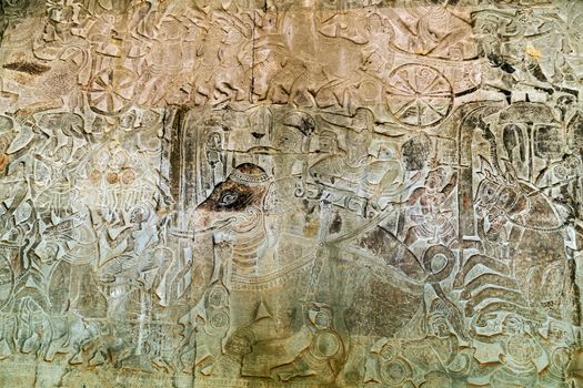 Khmer relief carving of gods fighting demons. Inner wall of the temple of Angkor Wat, Siem Reap, Cambodia.