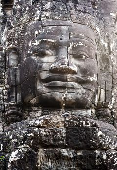 Buddhist Stone Khmer Smile face in Bayon Temple Angkor Thom, Cambodia. Ancient monument Khmer architecture.