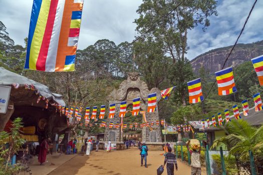 ADAM'S PEAK, SRI LANKA - February 05, 2016: Reclining Buddha statue at the foot of Adams Peak. Gate at the Base of SRI PADA Gateway to start of ascent ADAM PEAK, Monk of the Buddhist go with pilgrims. is the most popular pilgrim place in Sri Lanka.