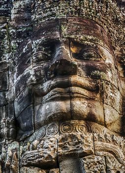 Ancient stone face smile Bayon Temple Angkor Thom Cambodia Khmer architecture.