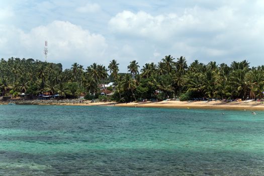 Tropical beach and turquiose ocean. Sri Lanka Vacation at Paradise.