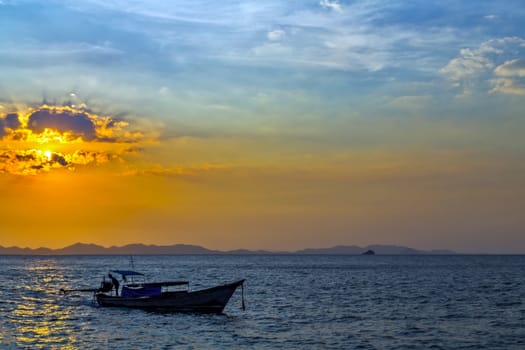 sunrise longtail boat with rock islands on horizon . Thailand Seascape andaman sea. Tourism travel sunrise