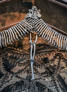 crossbone decoration wall building detail human bones and skulls. decor architecture design interior skeleton. Kostnice Church death skull - tourist attraction is a place Kutna Hora.