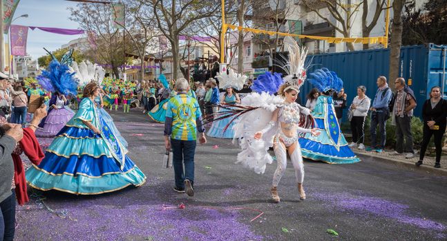 Loule, Portugal - February 25, 2020: dancers parading in the street in front of the public in the parade of the traditional carnival of Loule city on a February day