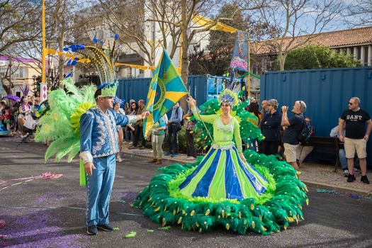 Loule, Portugal - February 25, 2020: dancers parading in the street in front of the public in the parade of the traditional carnival of Loule city on a February day