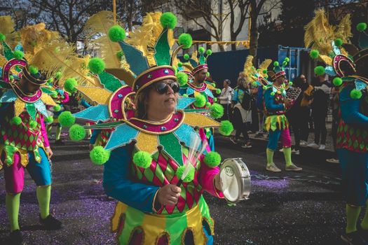 Loule, Portugal - February 25, 2020: percussionists parading in the street accompanying dancers in the parade of the traditional carnival of Loule city on a February day