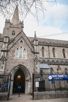 Dublin, Ireland - February 13, 2019: Street atmosphere and architecture of St Patrick's Cathedral that people visit on a winter day