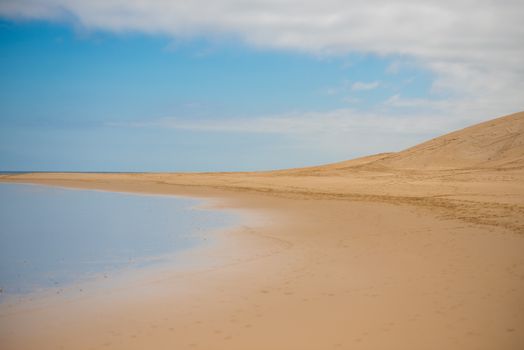 Blue sky along coastline with sanddune